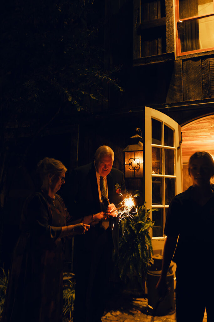 Mom and dad at daughters sparkler exit at Heartwood Hall Wedding