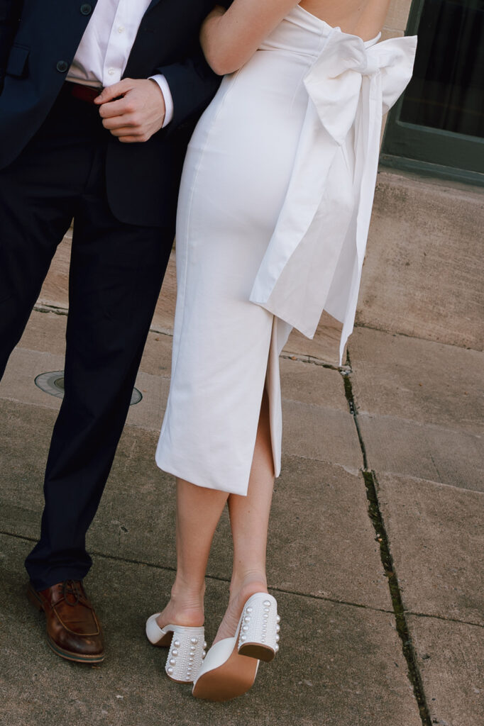 zoomed in photograph of a white dress with a bow for engagement photos