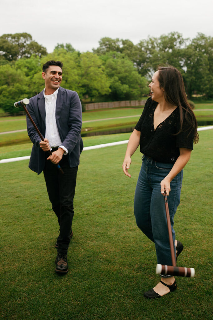 cute couple playing a game of croquet in the parkfor engagement photos